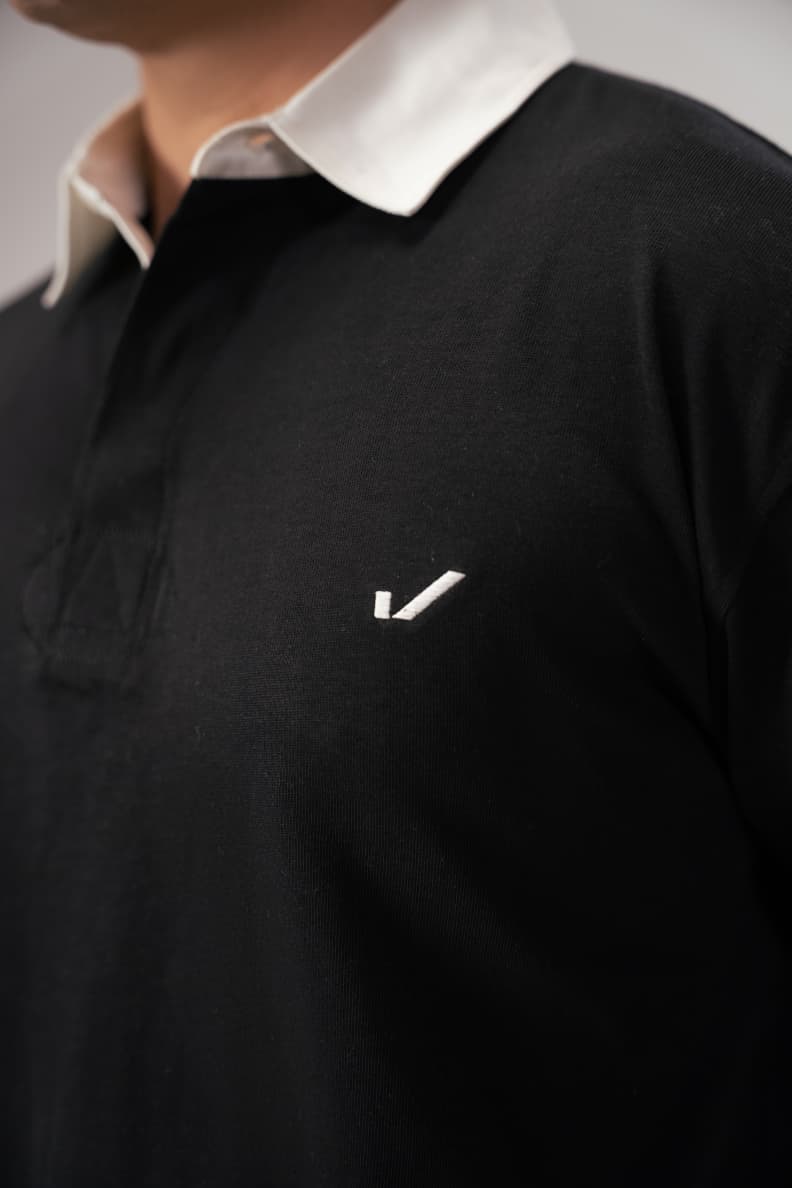 Close-up of logo on classic black rugby shirt Black/White