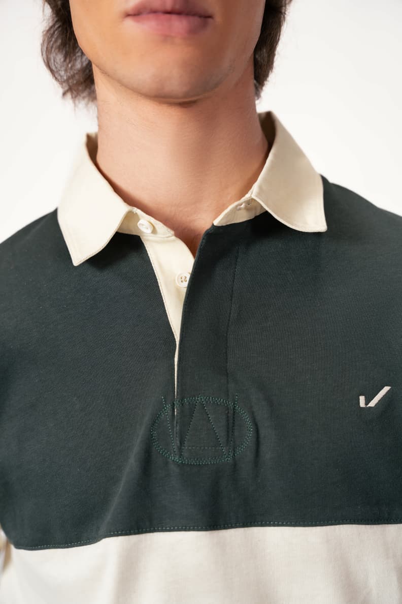 Close-up of green rugby shirt with cream collar Scarab/Cannoli Cream