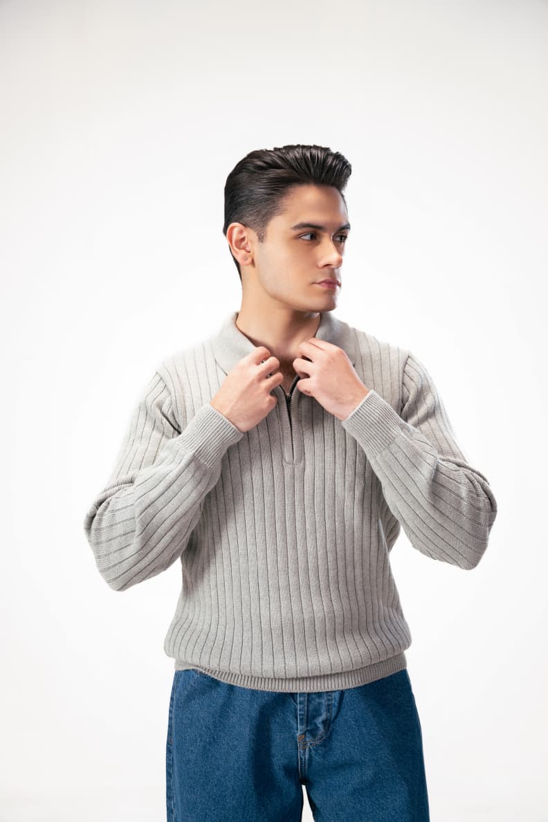 Model adjusting zip on grey textured sweater Grey
